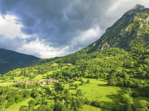 Spain, Asturias, Las Agueras, Aerial view of small village in Picos de Europa range - LAF02829