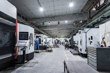 Technicians working and operating machinery in factory - AAZF00905