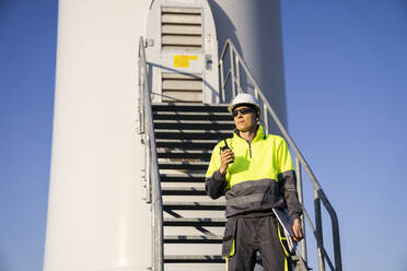 Engineer standing in front of wind turbine staircase - EKGF00512