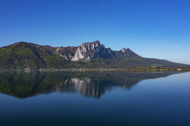 Austria, Upper Austria, Loibichl, Drone view of Drachenwand mountain reflecting in Mondsee lake - WWF06334