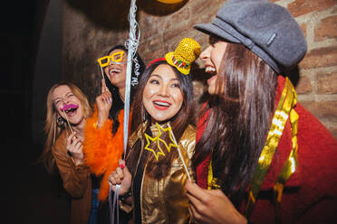 Gruppe glücklicher Mädchen, die eine Party in einem Club feiern - Vier junge Frauen feiern eine verrückte Geburtstagsparty in der Nacht - DMDF04380