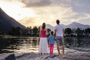 Familie bewundert See und Berge bei Sonnenuntergang - DIGF20567