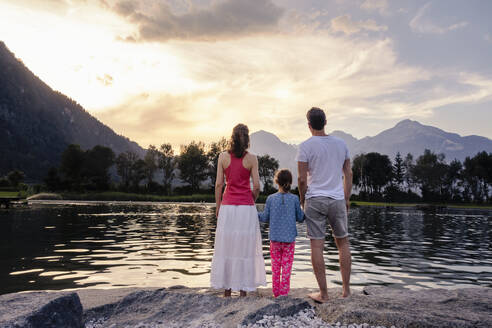 Family admiring lake and mountains at sunset - DIGF20567
