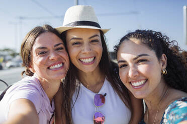 Happy woman taking selfie with friends on sunny day - DCRF01832