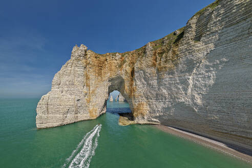 White chalk cliffs with natural arch under sky on sunny day - ANSF00622