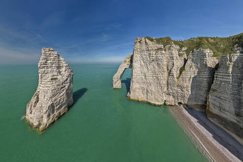 White chalk cliffs with natural arch under blue sky on sunny day - ANSF00623