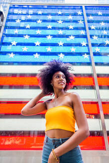 Happy african american woman smiling. Beautiful young female walking and having fun in New York city - DMDF04765