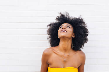 Happy african american woman smiling. Beautiful young female walking and having fun in New York city - DMDF04775