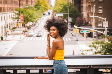 Happy african american woman smiling. Beautiful young female walking and having fun in New York city - DMDF04789