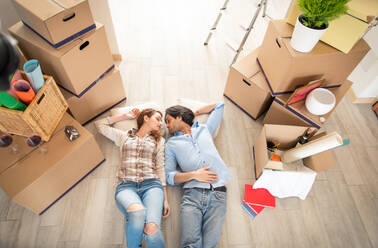 Couple moving to a new home - Happy married people buy a new apartment to start new life together - DMDF04794