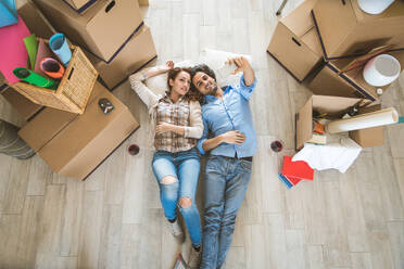 Couple moving to a new home - Happy married people buy a new apartment to start new life together - DMDF04795