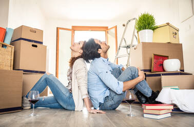 Couple moving to a new home - Happy married people buy a new apartment to start new life together - DMDF04796