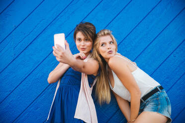 Girlfriends taking selfie with smartphone - DMDF04852