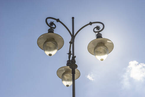 Germany, Mecklenburg-Vorpommern, Schwerin, Triple street light standing against sky - PVCF01383