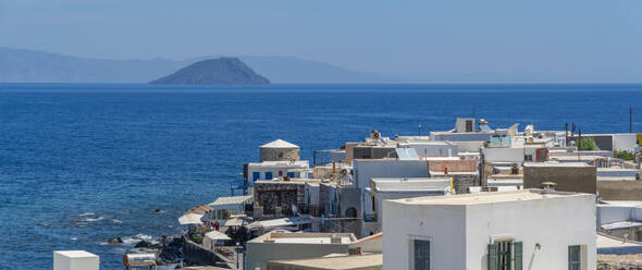 View of sea and whitewashed buildings and rooftops of Mandraki, Mandraki, Nisyros, Dodecanese, Greek Islands, Greece, Europe - RHPLF27308