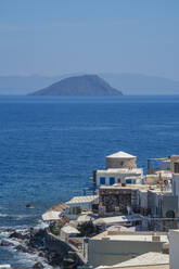 View of sea and whitewashed buildings and rooftops of Mandraki, Mandraki, Nisyros, Dodecanese, Greek Islands, Greece, Europe - RHPLF27309