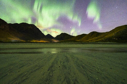 Starry sky with Aurora Borealis (Northern Lights) over the frozen Haukland beach, Lofoten Islands, Nordland, Norway, Scandinavia, Europe - RHPLF27358