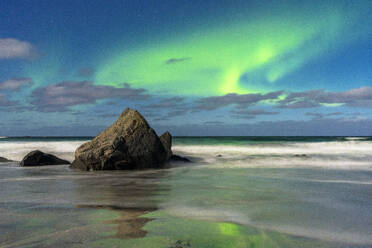 Waves crashing on rocks under a bright sky with te Aurora Borealis (Northern Lights), Skagsanden beach, Ramberg, Lofoten Islands, Nordland, Norway, Scandinavia, Europe - RHPLF27362