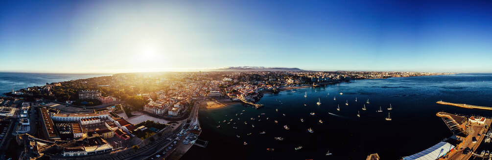 Aerial drone panoramic view of sunset at Cascais Bay, in the Lisbon region of the Portuguese Riveira, Europe - RHPLF27478