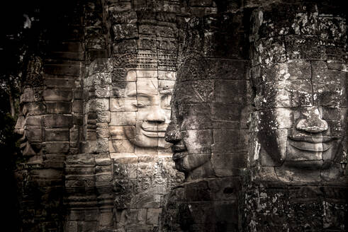Ancient faces carved in stone at Bayon temple, Angkor Wat, UNESCO World Heritage Site, Cambodia, Indochina, Southeast Asia, Asia - RHPLF27531