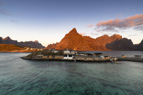 Sunrise over Olstind mountain and fishing village of Sakrisoy overlooking the crystal sea, Lofoten Islands, Nordland, Norway, Scandinavia, Europe - RHPLF27578