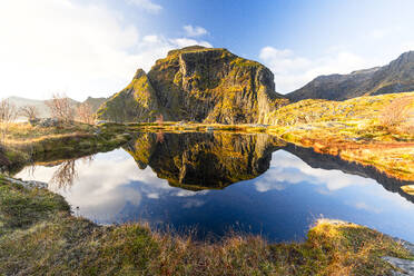 Mountains mirrored in the pristine blue water in autumn, A i Lofoten, Moskenes, Lofoten Islands, Nordland, Norway, Scandinavia, Europe - RHPLF27581