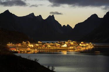 Silhouettes of mountains framing the fairy tale village along the fjord at dawn, Reine Bay, Lofoten Islands, Nordland, Norway, Scandinavia, Europe - RHPLF27599