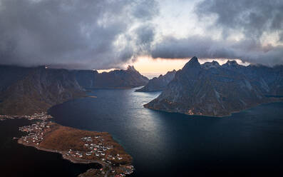 Storm clouds at sunset over majestic mountains along a fjord, aerial view, Reine Bay, Lofoten Islands, Nordland, Norway, Scandinavia, Europe - RHPLF27602