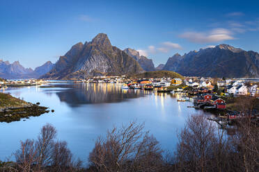 Dusk over majestic Olstind mountain overlooking the iconic harbor of the fishing village of Reine, Lofoten Islands, Nordland, Norway, Scandinavia, Europe - RHPLF27603