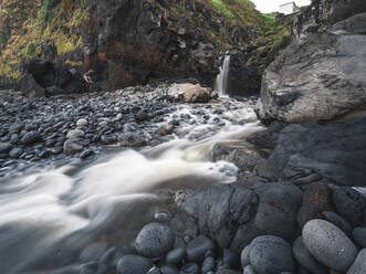 Long exposure of a waterfall falling into the ocean in Porto de Pescas da Achada on Sao Miguel island, Azores Islands, Portugal, Atlantic, Europe - RHPLF27751