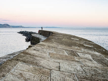 Taking a photograph at the end of The Cobb at sunset, Lyme Regis, Dorset, England, United Kingdom, Europe - RHPLF27787