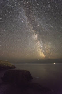 An autumn view of the Milky Way over the Atlantic Ocean, seen from the cliffs of Land's End, the most southwesterly point of Great Britain, Cornwall, England, United Kingdom, Europe - RHPLF27927