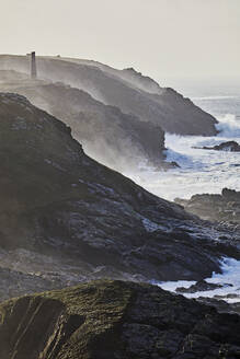 Atlantic cliffs pounded by surf in stormy winter weather, at Pendeen, with the ruins of old tin mines, part of the UNESCO World Heritage Site Cornwall and West Devon Mining Landscape, near St. Just, Cornwall, England, United Kingdom, Europe - RHPLF27937