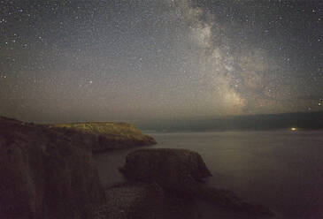 An autumn view of the Milky Way over the Atlantic Ocean, seen from the cliffs of Land's End, the most southwesterly point of Great Britain, Cornwall, England, United Kingdom, Europe - RHPLF27956