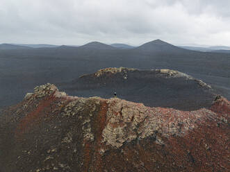 A person enjoy the beautiful landscape from the mouth of old volcano, Highlands, Iceland, Polar Regions - RHPLF28001