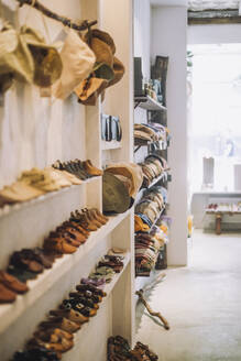 Caps and footwear on display rack at fashion boutique - MASF38660