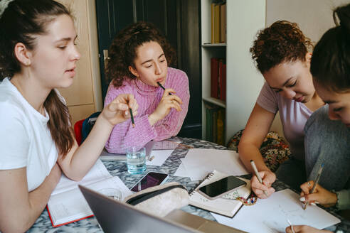 Female friends studying together while doing homework - MASF38746