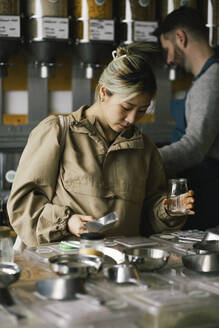 Young woman buying food from sustainable store - MASF38867