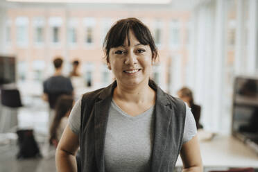 Portrait of smiling female professor in university - MASF39053