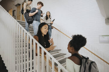 Multiracial students on steps in university - MASF39072