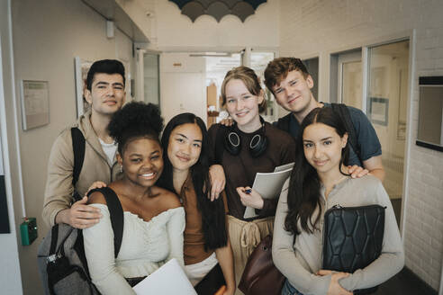 Portrait of happy multiracial students at university - MASF39120