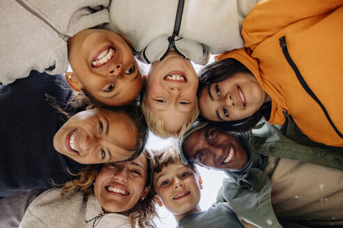 Directly below shot of children huddling with counselors - MASF39516