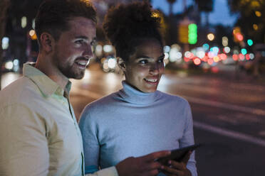 Happy businesswoman and businessman with tablet PC at street - JOSEF20977