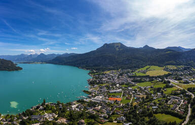 Austria, Upper Austria, Sankt Gilgen, Drone view of Lake Wolfgangsee and surrounding town in summer - WWF06406