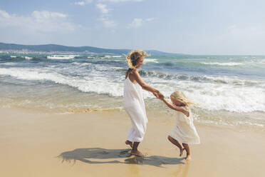 Happy mother and daughter enjoying at beach - SIF00860