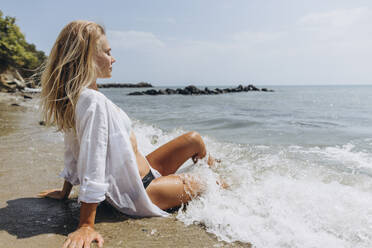 Woman with eyes closed relaxing at beach - SIF00884