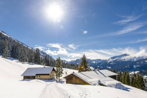 Austria, Vorarlberg, Sun shining over secluded huts in Allgau Alps - EGBF00946
