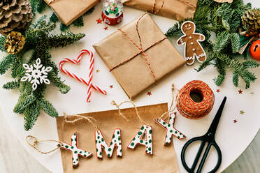 From above composition of various Christmas decorations and yummy cookies and candy canes on table - ADSF46720