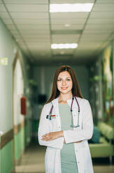 Female doctor with stethoscope standing at medical clinic - ADF00173