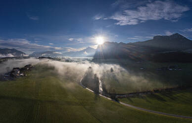 Austria, Upper Austria, Mondsee, Drone view of foggy sunrise over Salzkammergut mountains in autumn - WWF06496